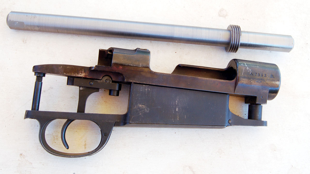 The mandrel screws into action, allowing mounting in the lathe. A tool post grinder then trues the  receiver ring but it can also grind off the crest and stamping on the left receiver wall.